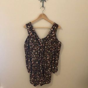 Flirty and fun cold shoulder open back romper!